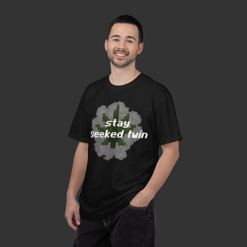 Man wearing a black t-shirt with 'stay geeked twin' text and pixelated design on a white background
